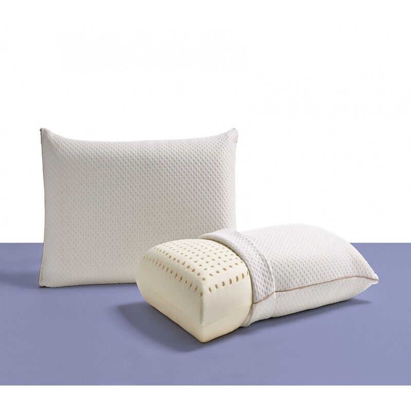 almohada-latex (2) Almohada de látex natural sobre cama vestida, destacando su forma ergonómica, superficie ventilada y tejido suave, ideal para un descanso fresco y saludable
