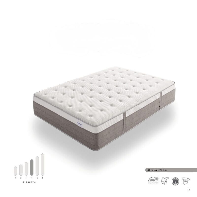 Colchón Hybrid Premium con diseño de doble capa, que combina espuma viscoelástica y muelles ensacados para mayor confort. Imagen del colchón sobre base tapizada, en dormitorio moderno y luminoso.